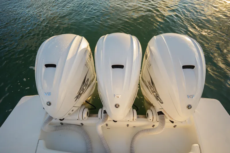 Slide: The Image of Triple Yamaha outboard engines on a 2020 Tiara Yachts 43 LS, docked on water. - 17
