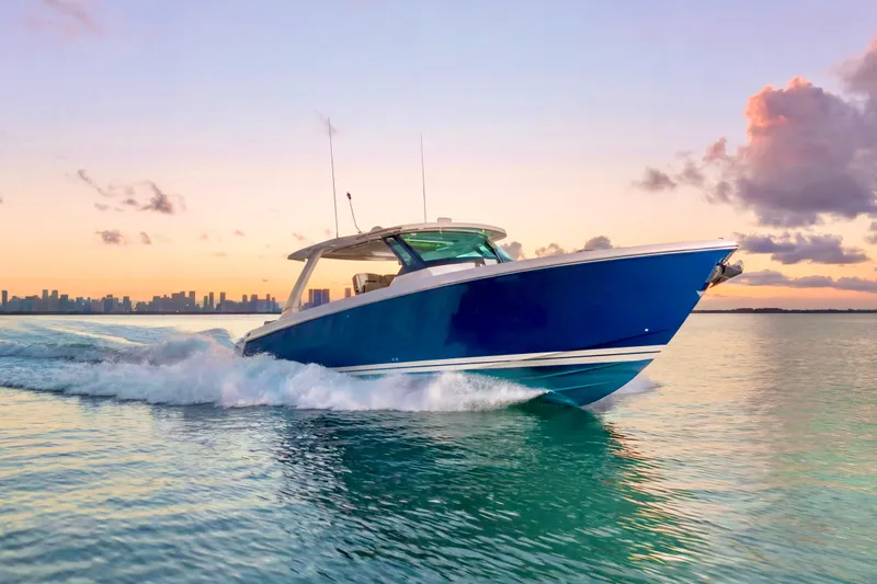 Slide: The Image of 2020 Tiara Yachts 43 LS cruising at sunset on calm waters. - 2