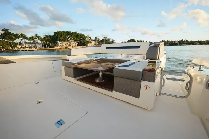 Slide: The Image of 2020 Tiara Yachts 43 LS luxury yacht deck with seating, overlooking serene waterfront. - 20