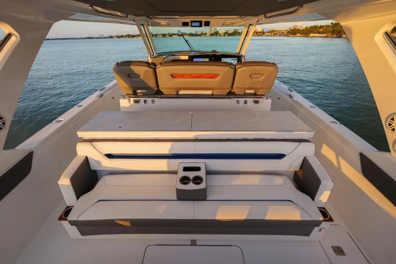 Slide: The Image of 2020 Tiara Yachts 43 LS luxury boat interior with seating, on calm water. - 23