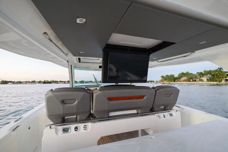 Slide: The Image of 2020 Tiara Yachts 43 LS interior with TV, luxurious seating, and scenic water view. - 24