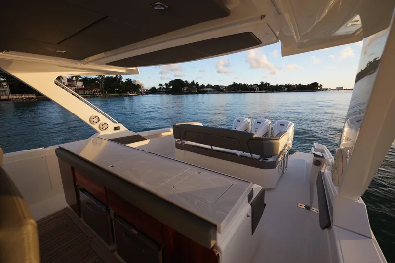 Slide: The Image of 2020 Tiara Yachts 43 LS interior, featuring luxurious seating and scenic waterfront view. - 26