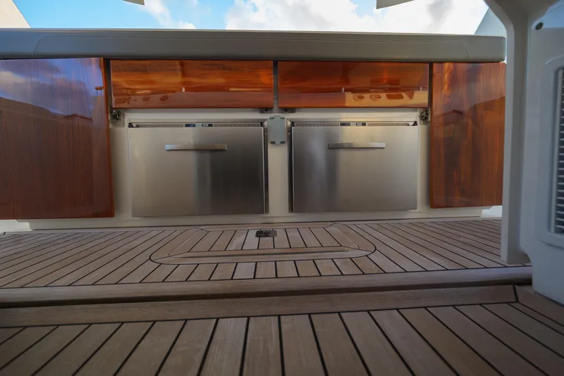 Slide: The Image of 2020 Tiara Yachts 43 LS interior with wooden cabinetry and stainless steel appliances. - 30