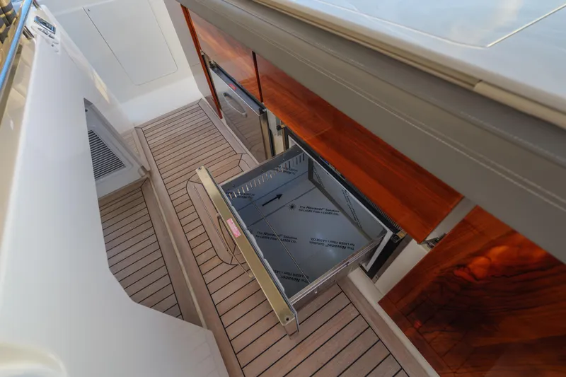 Slide: The Image of 2020 Tiara Yachts 43 LS with open storage compartment and teak flooring. - 31