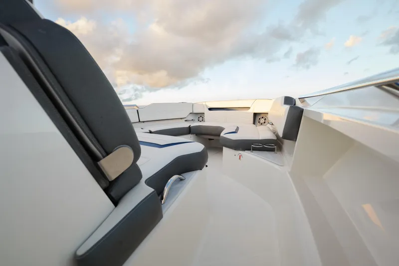 Slide: The Image of Luxurious seating area on 2020 Tiara Yachts 43 LS under a cloudy sky. - 37
