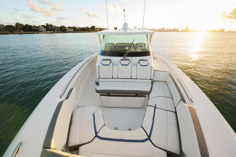 Slide: The Image of 2020 Tiara Yachts 43 LS on serene water at sunset, showcasing luxurious seating. - 39