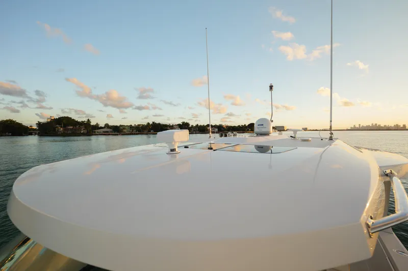 Slide: The Image of 2020 Tiara Yachts 43 LS on calm water at sunset, showcasing sleek design. - 45