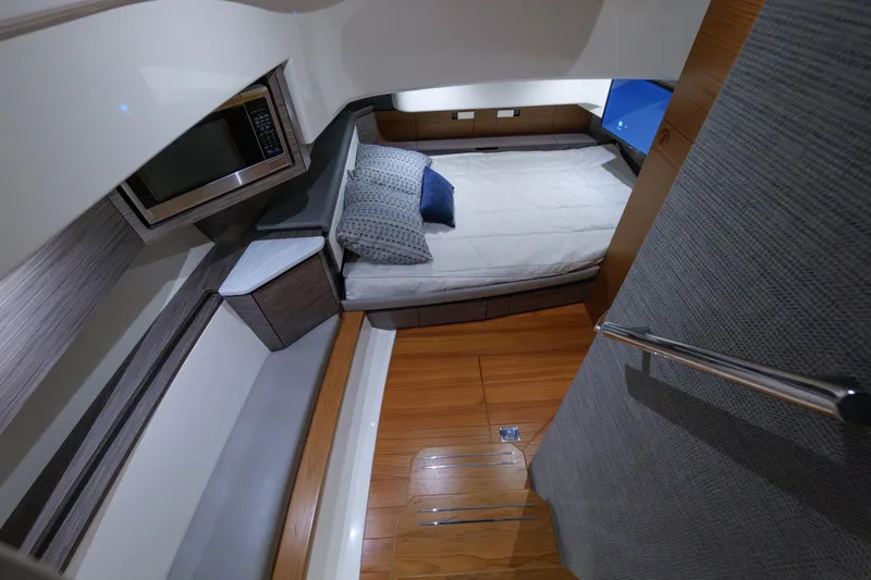 Slide: The Image of 2020 Tiara Yachts 43 LS cabin interior with bed, microwave, and modern design. - 49