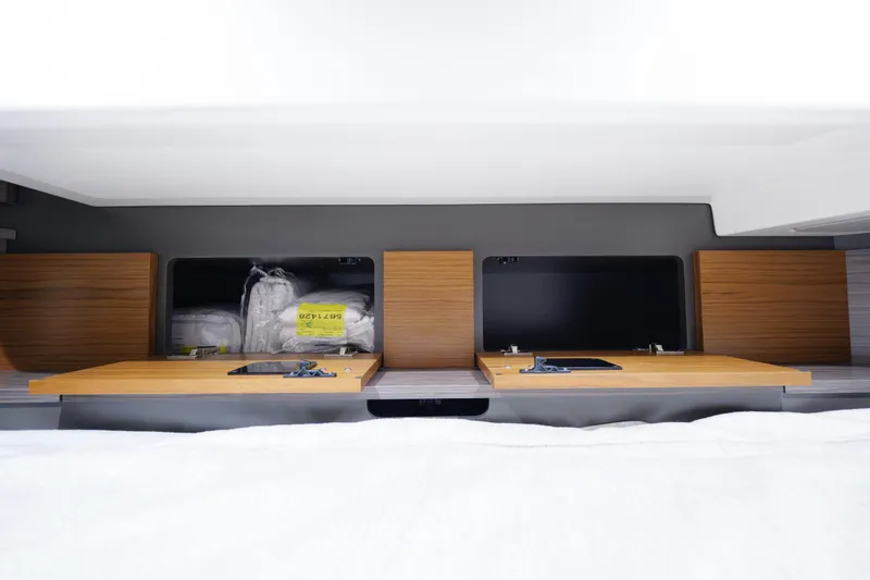 Slide: The Image of Interior storage compartments of 2020 Tiara Yachts 43 LS, featuring wooden panels and organized space. - 52