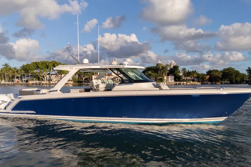 Slide: The Image of 2020 Tiara Yachts 43 LS boat on water, blue hull, scenic background. - 7