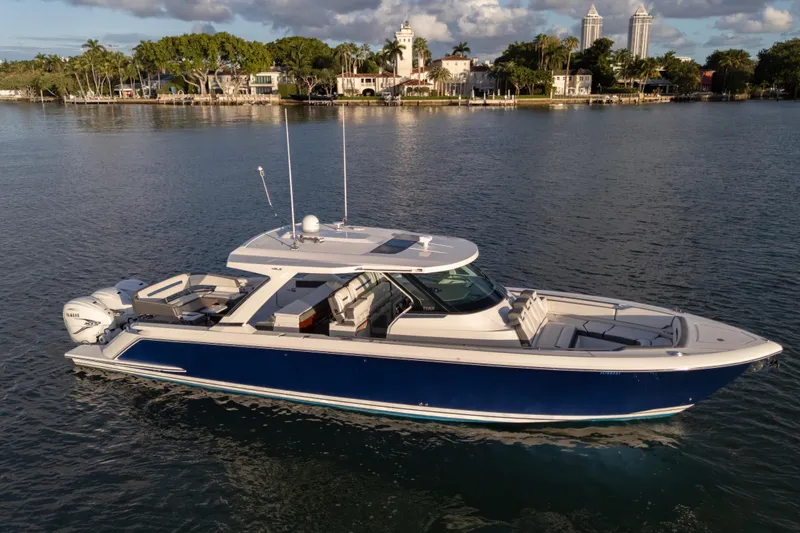 Slide: The Image of 2020 Tiara Yachts 43 LS boat on calm water, with scenic waterfront background. - 8