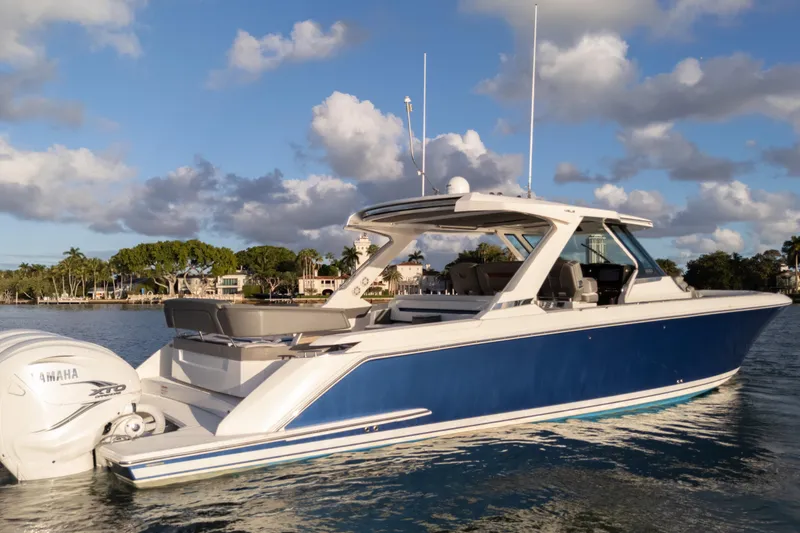 Slide: The Image of 2020 Tiara Yachts 43 LS in water, blue hull, Yamaha engines, scenic background. - 9