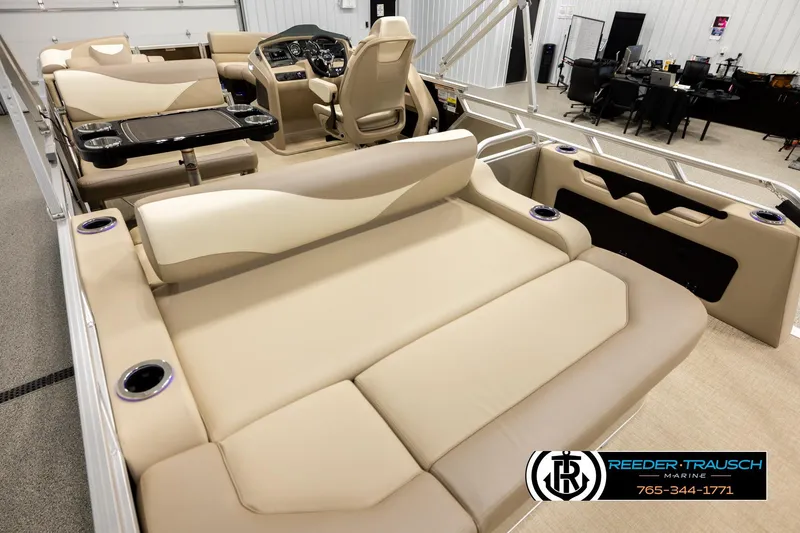 Slide: The Image of 2026 Avalon LSZ ENT pontoon boat interior with beige seating and modern dashboard. - 11