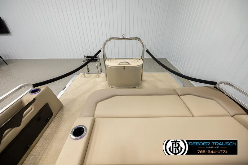 Slide: The Image of 2026 Avalon LSZ ENT boat interior with beige seating and cup holders, displayed indoors. - 15