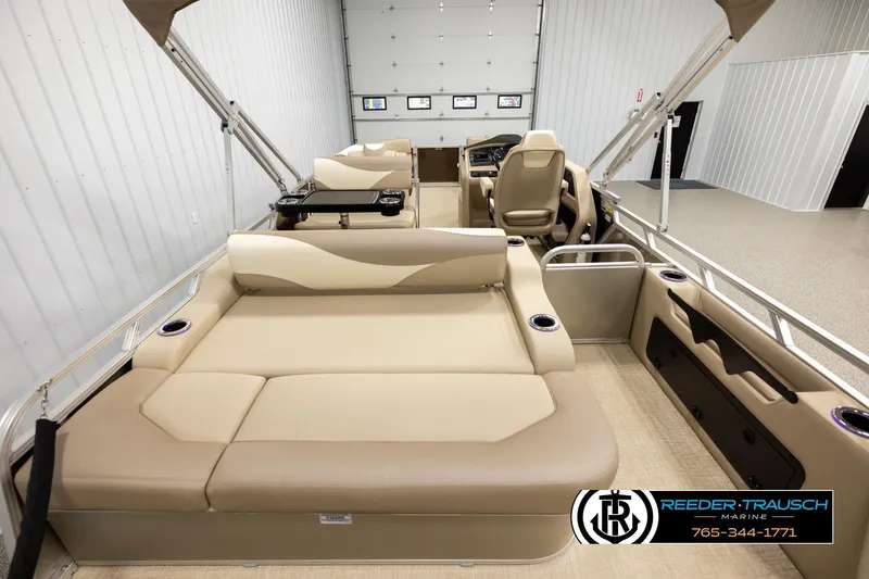 Slide: The Image of 2026 Avalon LSZ ENT pontoon boat interior with beige seating and modern amenities. - 16