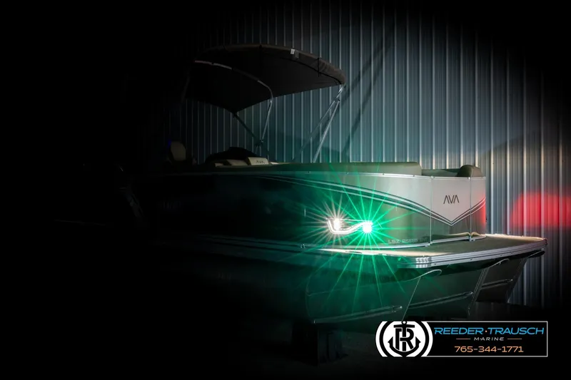 Slide: The Image of 2026 Avalon LSZ ENT pontoon boat with illuminated lights in a dimly lit setting. - 4