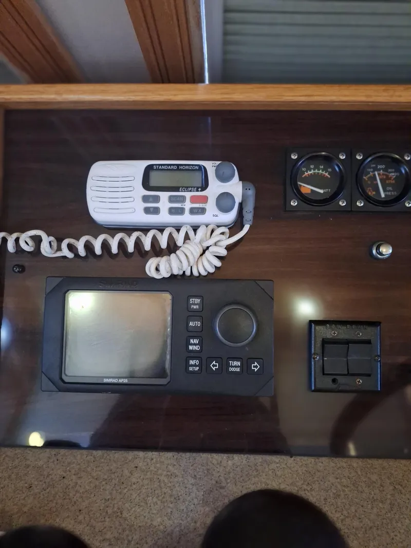 Slide: The Image of Control panel of a 1988 Viking Motor Yacht with radio and gauges. - 12