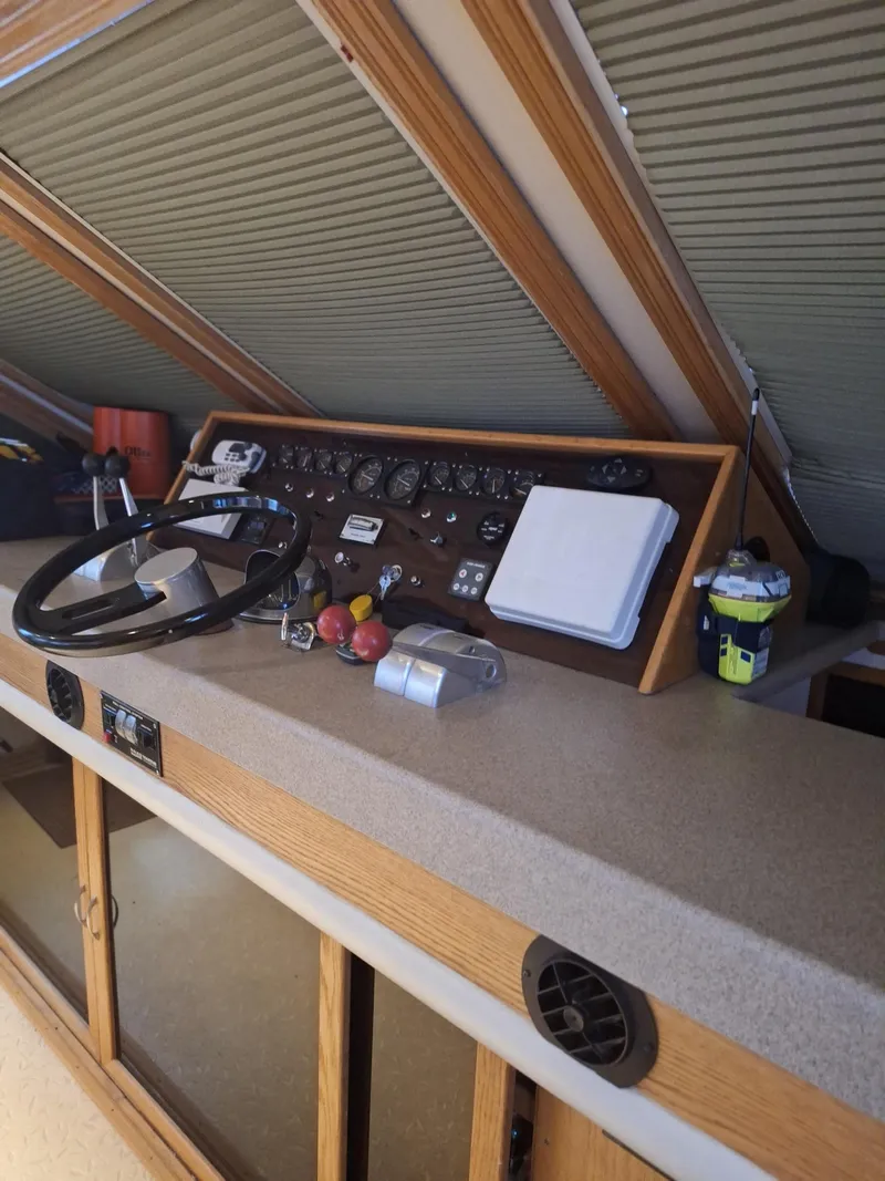 Slide: The Image of 1988 Viking Motor Yacht helm with steering wheel and control panel. - 15