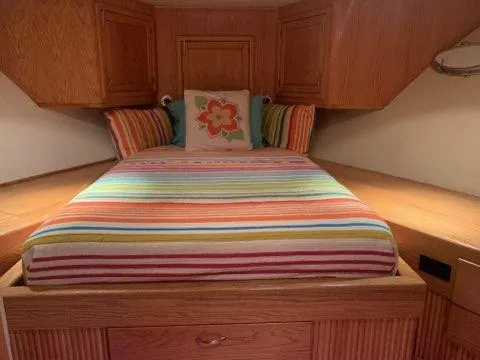 Slide: The Image of Cozy bedroom in a 1988 Viking Motor Yacht with colorful striped bedding. - 18