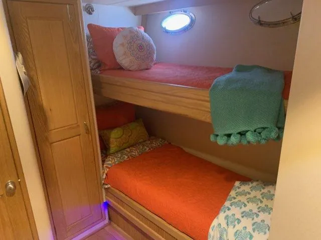 Slide: The Image of Cozy bunk beds in a 1988 Viking Motor Yacht cabin with vibrant bedding. - 19