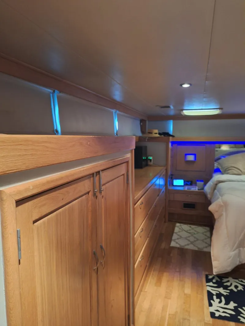 Slide: The Image of 1988 Viking Motor Yacht interior with wooden cabinetry and modern lighting. - 21