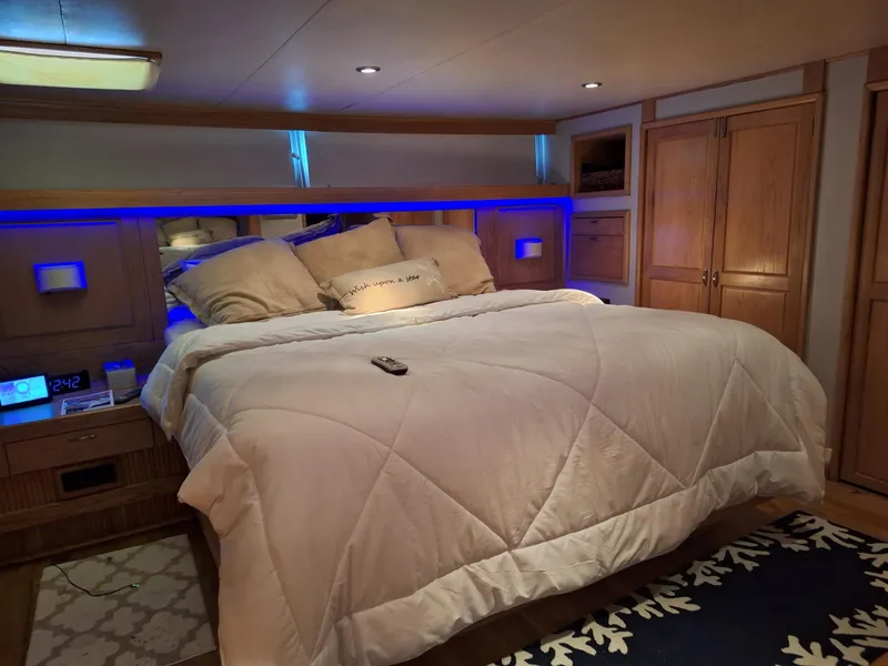 Slide: The Image of Luxurious bedroom in a 1988 Viking Motor Yacht with cozy bedding and ambient lighting. - 22