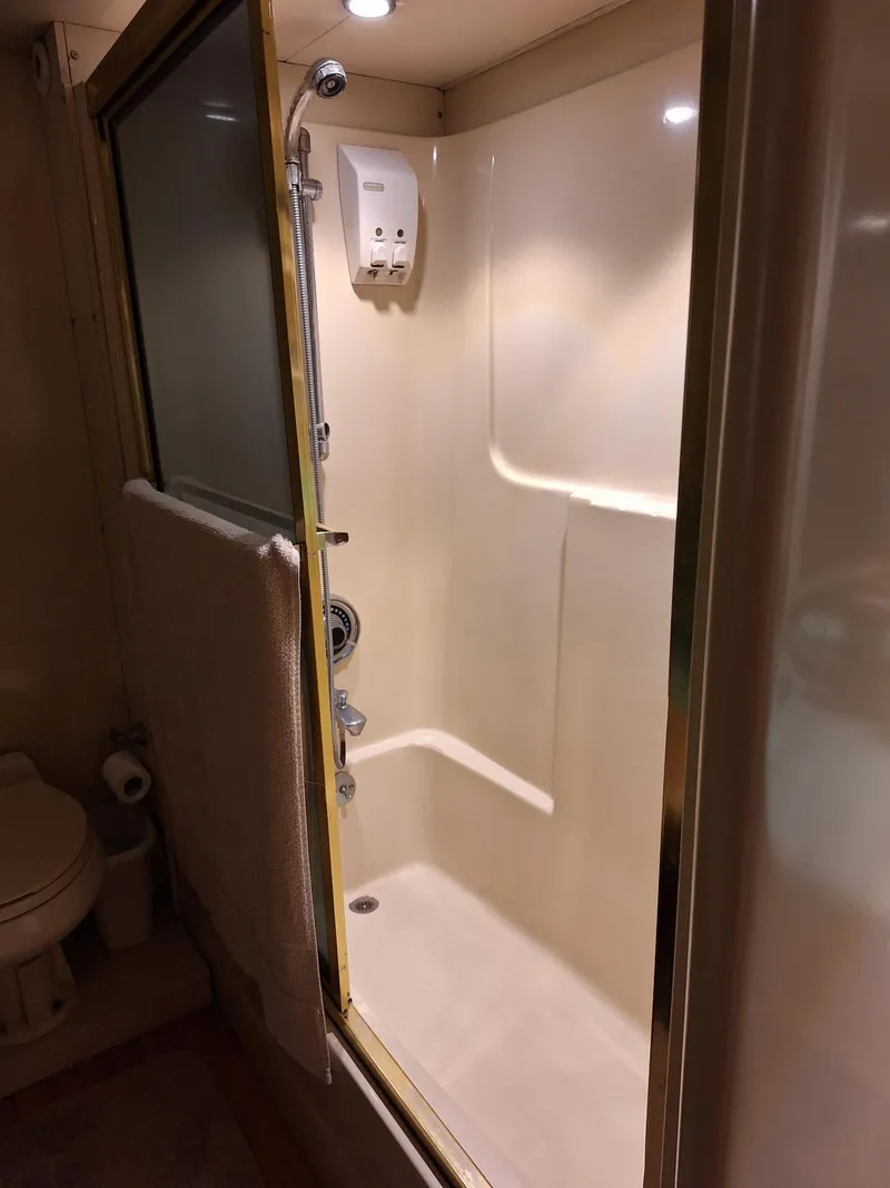 Slide: The Image of 1988 Viking Motor Yacht bathroom with shower and toilet. - 24