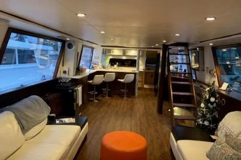 Slide: The Image of Luxurious interior of a 1988 Viking Motor Yacht with modern furnishings and wooden flooring. - 25