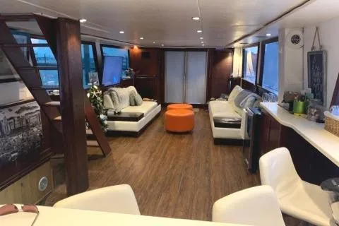 Slide: The Image of Luxurious interior of a 1988 Viking Motor Yacht with modern furnishings and wooden flooring. - 26