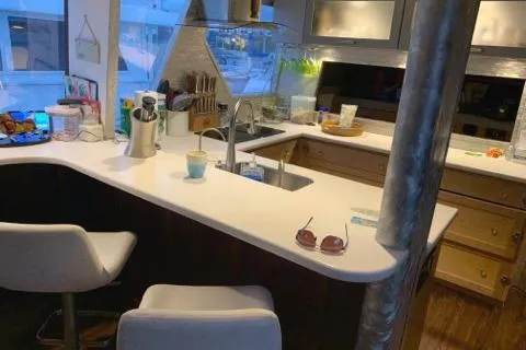 Slide: The Image of 1988 Viking Motor Yacht kitchen with modern amenities and white countertops. - 27