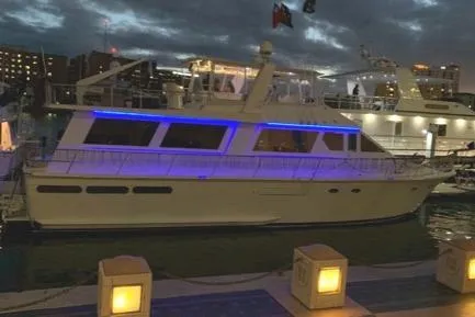 Slide: The Image of 1988 Viking Motor Yacht docked at night with blue accent lighting. - 29