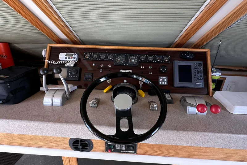 Slide: The Image of Control panel of a 1988 Viking Motor Yacht with steering wheel and navigation instruments. - 31