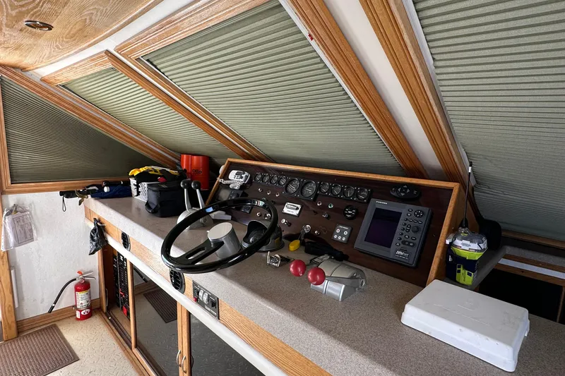 Slide: The Image of 1988 Viking Motor Yacht helm station with steering wheel, controls, and navigation instruments. - 32