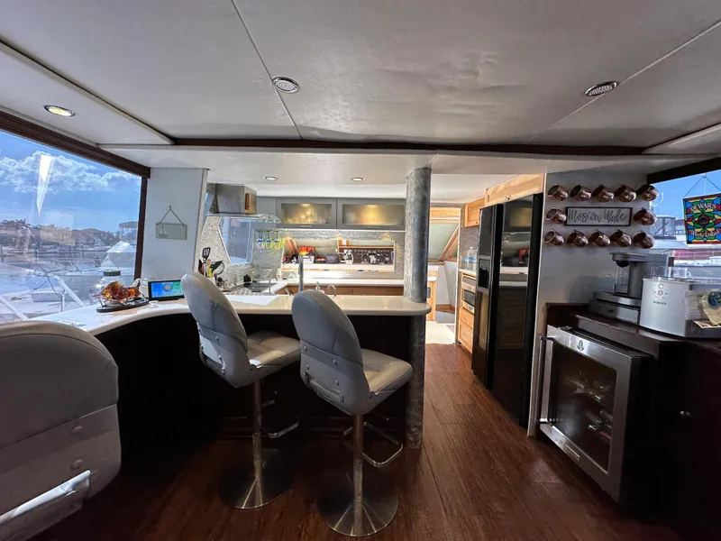 Slide: The Image of 1988 Viking Motor Yacht interior with modern kitchen and bar stools. - 35
