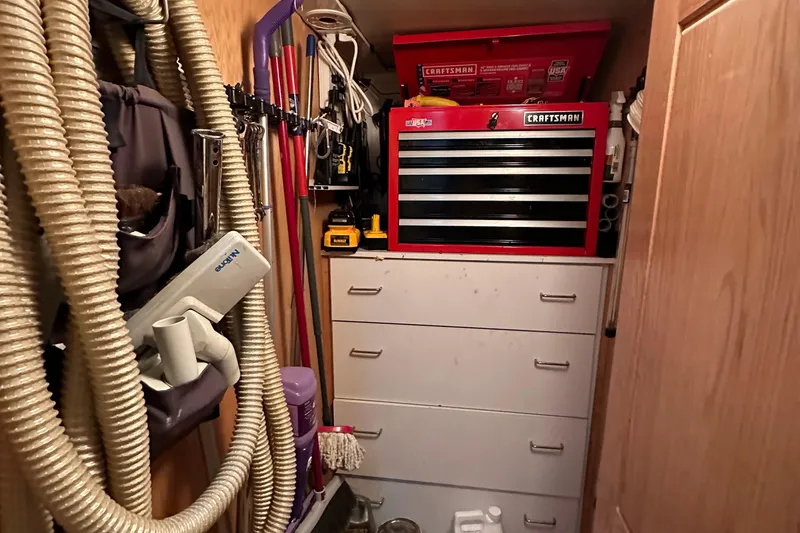 Slide: The Image of Storage area on a 1988 Viking Motor Yacht with tools and cleaning supplies. - 40
