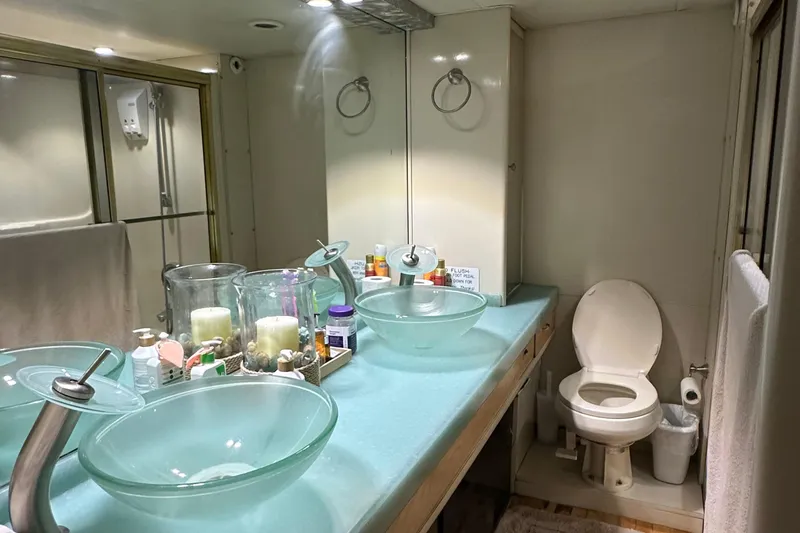 Slide: The Image of 1988 Viking Motor Yacht bathroom with dual glass vessel sinks and modern fixtures. - 42