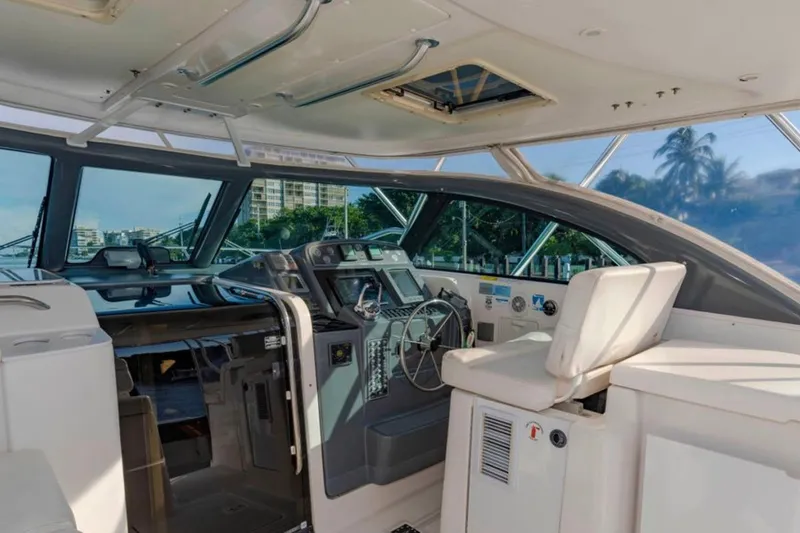 Slide: The Image of Interior view of 2004 Pursuit 3800 Express yacht cockpit with steering wheel and seating. - 14
