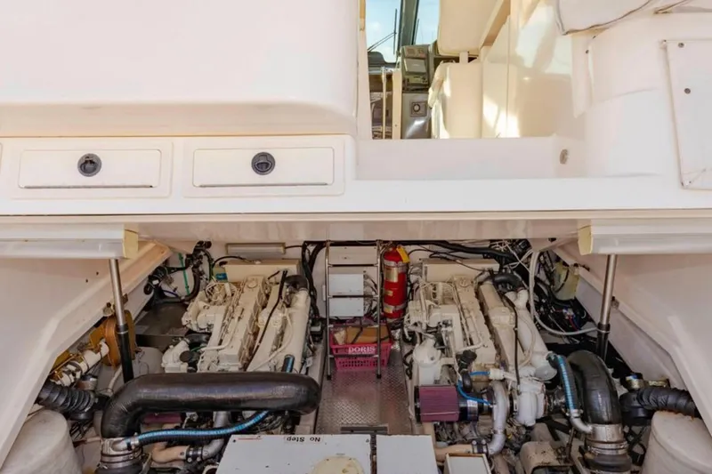 Slide: The Image of Engine compartment of a 2004 Pursuit 3800 Express boat, showcasing dual engines and equipment. - 19