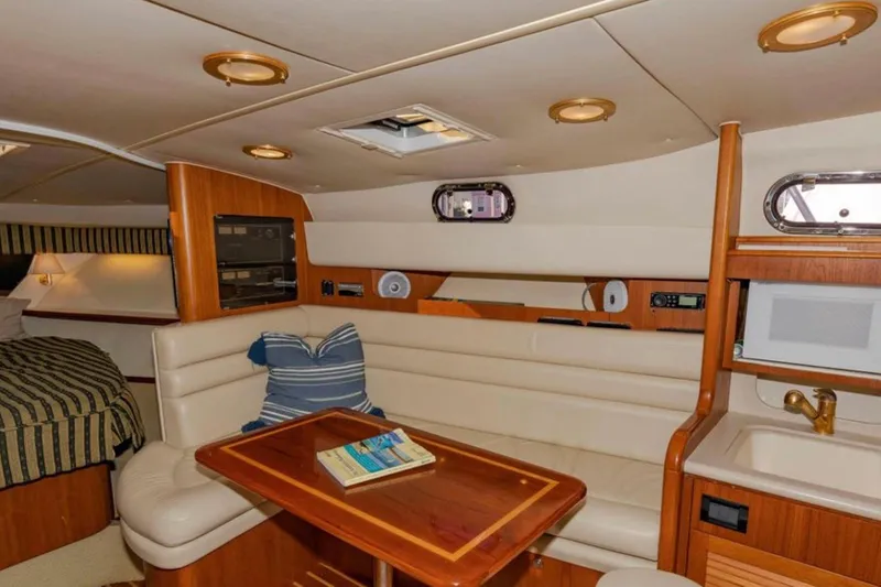 Slide: The Image of Luxurious interior of 2004 Pursuit 3800 Express yacht with seating, table, and kitchenette. - 5