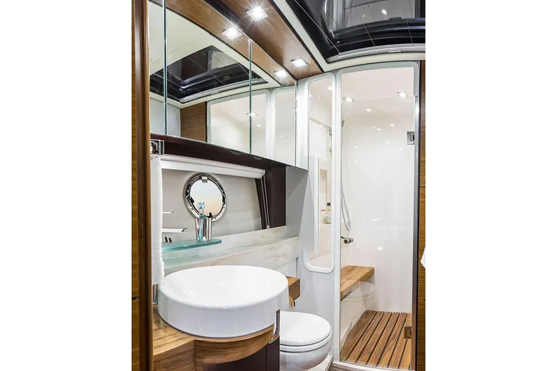 Slide: The Image of Manufacturer Provided Image: Modern bathroom in 2020 Tiara Yachts C53 Coupe with shower, toilet, and wooden accents. - 11