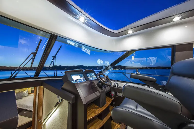 Slide: The Image of 2020 Tiara Yachts C53 Coupe with white seating, overlooking a serene ocean view. - 5