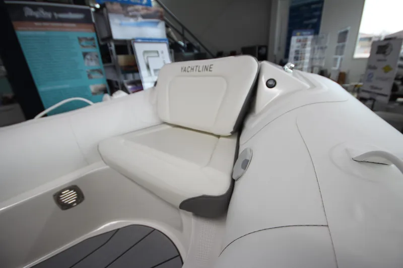 Slide: The Image of 2026 Zodiac Yachtline 400 interior seating, showcasing sleek white design and modern features. - 16
