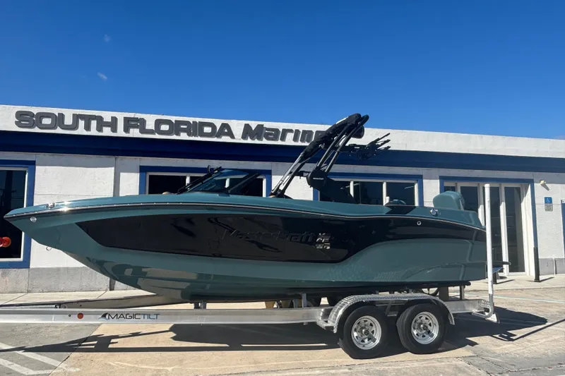 The Image of 2026 MasterCraft XT22 boat on trailer at South Florida Marine dealership. - 1