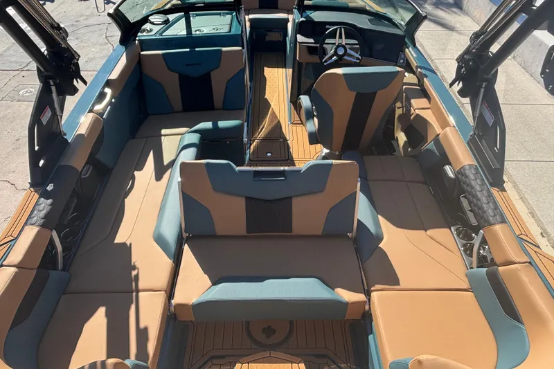 Slide: The Image of 2026 MasterCraft XT22 boat interior with tan and blue seating, modern design. - 11
