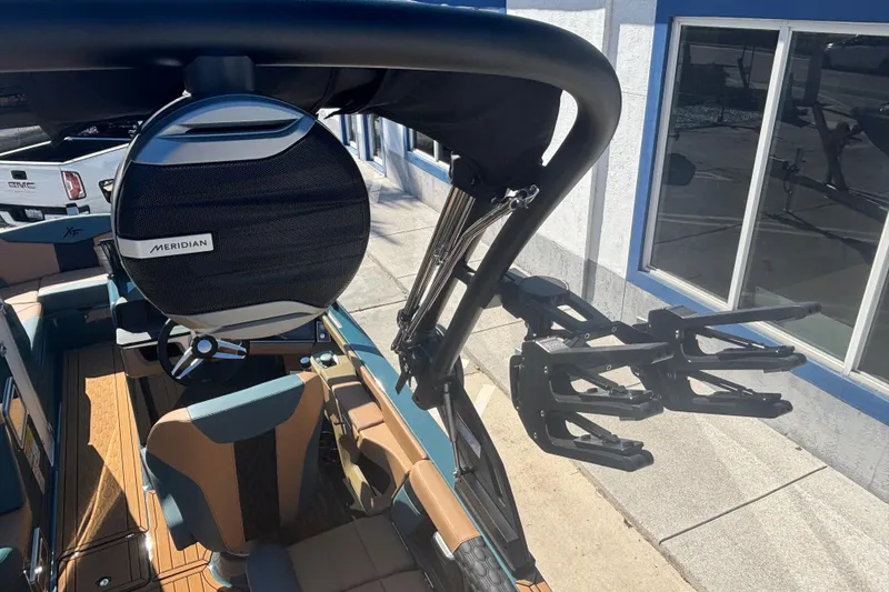 Slide: The Image of 2026 MasterCraft XT22 boat interior with Meridian speaker and wakeboard racks. - 15