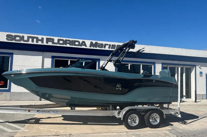Slide: The Image of 2026 MasterCraft XT22 boat on trailer at South Florida Marine dealership. - 2