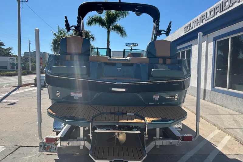 Slide: The Image of 2026 MasterCraft XT22 boat on trailer, parked outside South Florida dealership. - 5