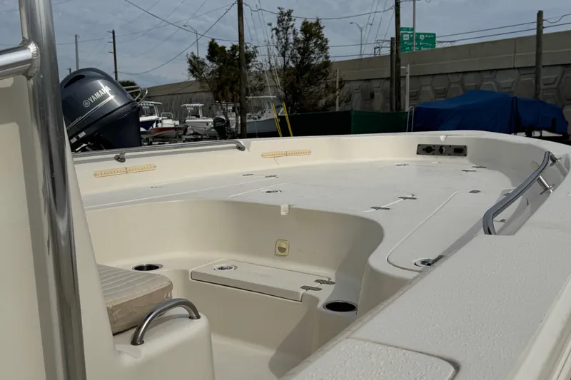 Slide: The Image of 2015 SeaChaser 23LX boat interior with Yamaha engine, docked outdoors. - 5
