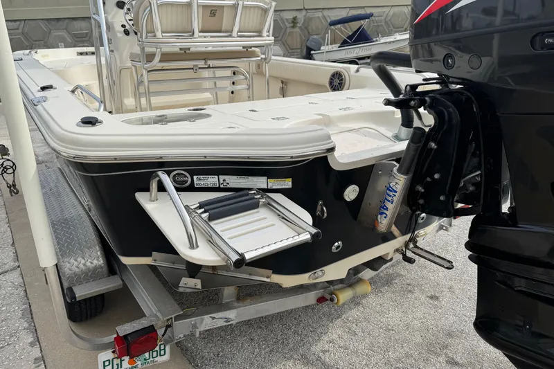 Slide: The Image of 2015 SeaChaser 23LX boat on trailer, featuring rear view with motor and swim ladder. - 9