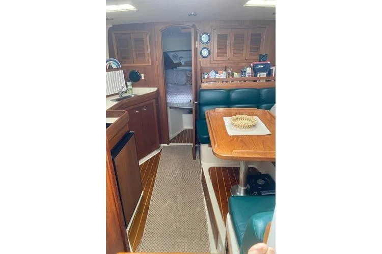 Slide: The Image of Interior of 2000 Mainship Pilot 34 Sedan with cozy dining and sleeping areas. - 11